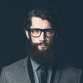 Young man with a beard and glasses